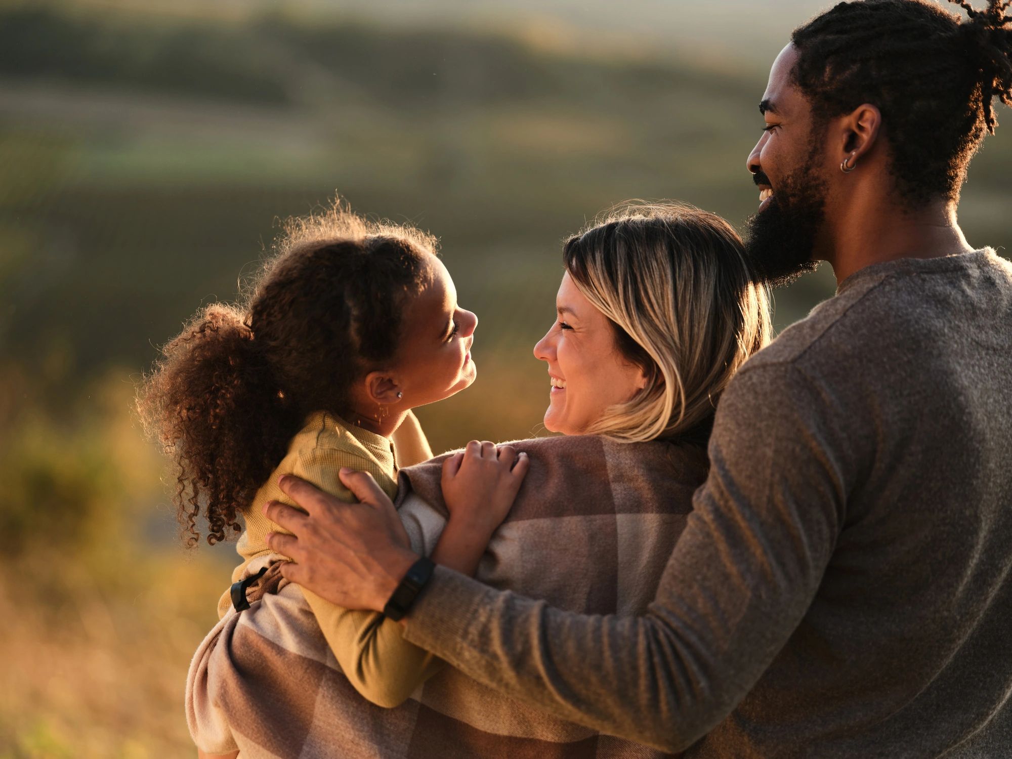 Family outdoors at sunset